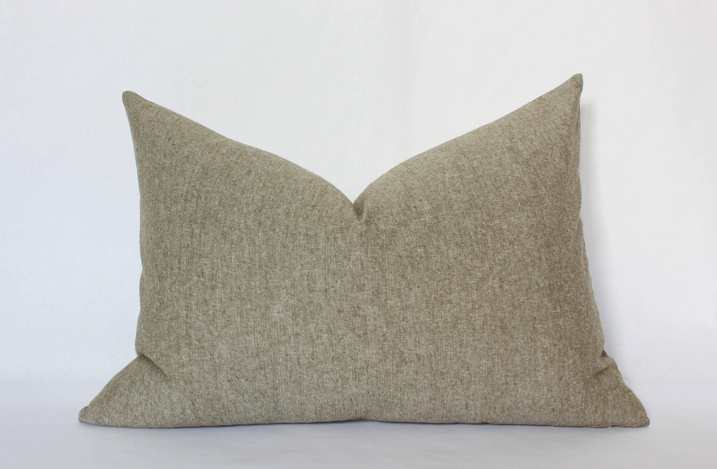 Neutral beige textured rectangular pillow on white background. Come see us at Awaken, Franklin, Tennessee
