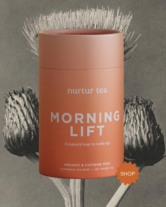 Organic Morning Lift caffeine-free nurtur tea container against natural botanical backdrop. Come see us at Awaken, Franklin, Tennessee