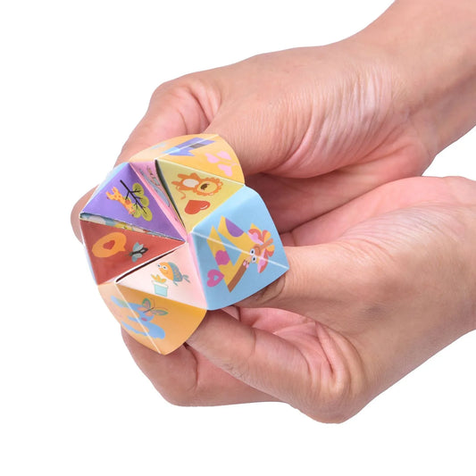 Hands holding colorful paper fortune teller with animal illustrations. Come see us at Awaken, Franklin, Tennessee
