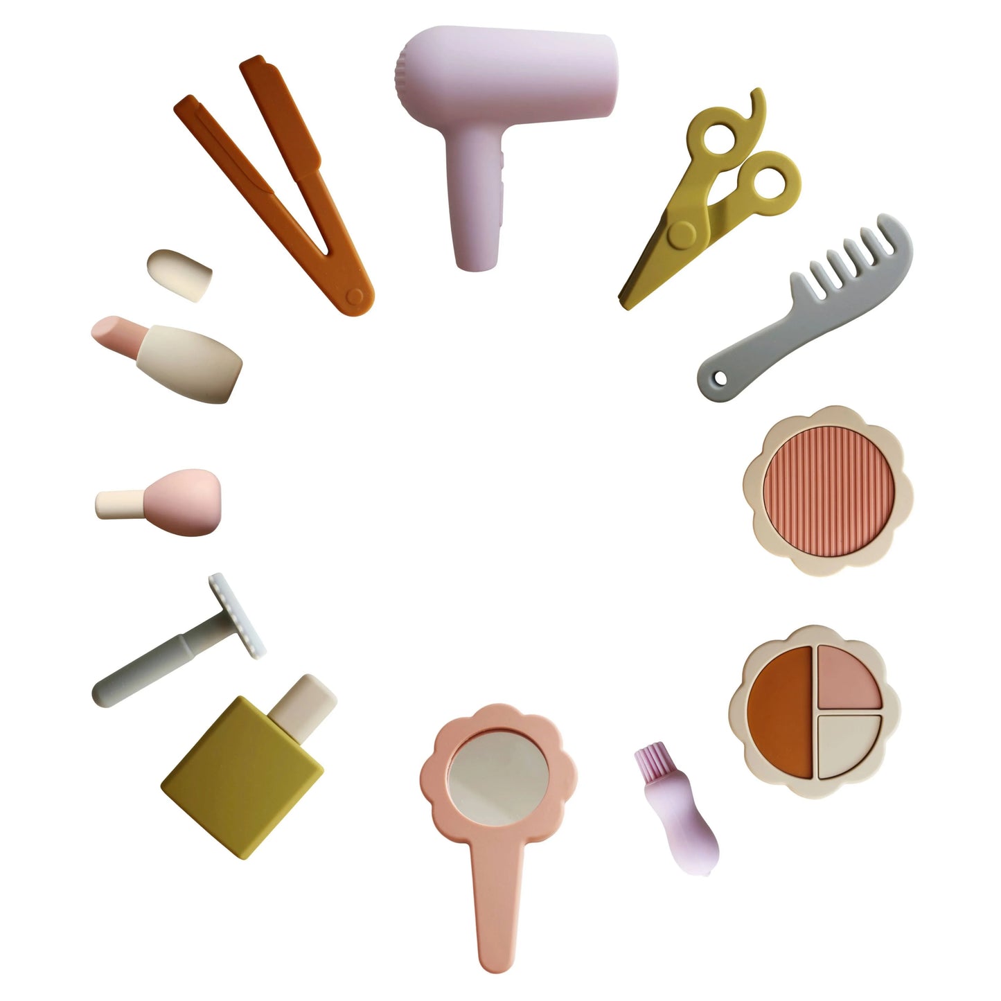 Circle of pastel-colored toy beauty accessories including hairdryer, scissors, comb, and mirror. Come see us at Awaken, Franklin, Tennessee