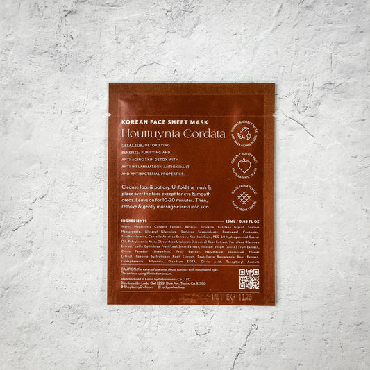 Korean face sheet mask Houttuynia Cordata with detoxifying, anti-aging benefits on concrete background. Come see us at Awaken, Franklin, Tennessee