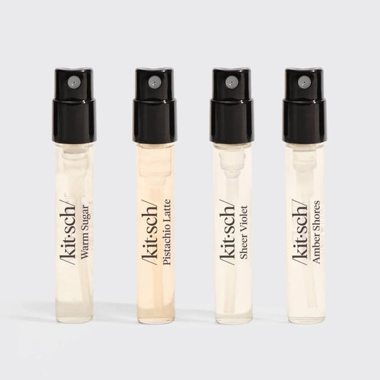 Four kitsch perfume spray samples Warm Sugar, Pistachio Latte, Sheer Violet, Amber Shores with black caps. Come see us at Awaken, Franklin, Tennessee