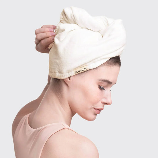 Woman with a white hair towel wrap, soft fabric, light pink top. Come see us at Awaken, Franklin, Tennessee