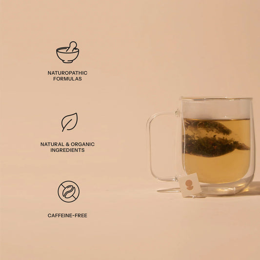 Glass cup of herbal tea with tea bag, highlighting naturopathic formulas, organic ingredients, caffeine-free, Come see us at Awaken, Franklin, Tennessee