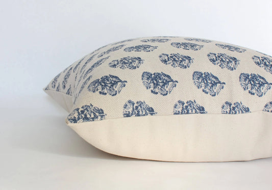 Beige pillow with blue floral leaf prints on light background Come see us at Awaken, Franklin, Tennessee