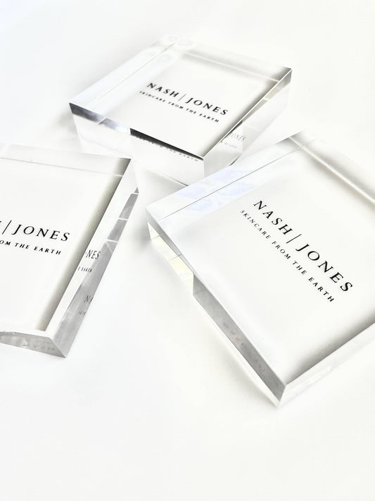 Nash Jones clear acrylic blocks with skincare branding on white background. Come see us at Awaken, Franklin, Tennessee