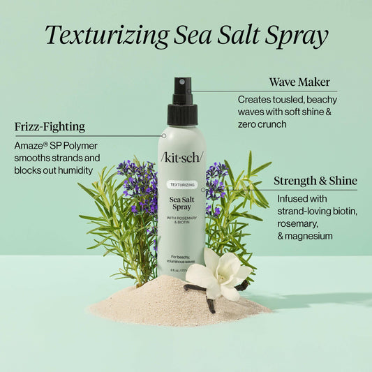 Kitsch Texturizing Sea Salt Spray with rosemary, biotin, and vanilla flower on sand. Come see us at Awaken, Franklin, Tennessee