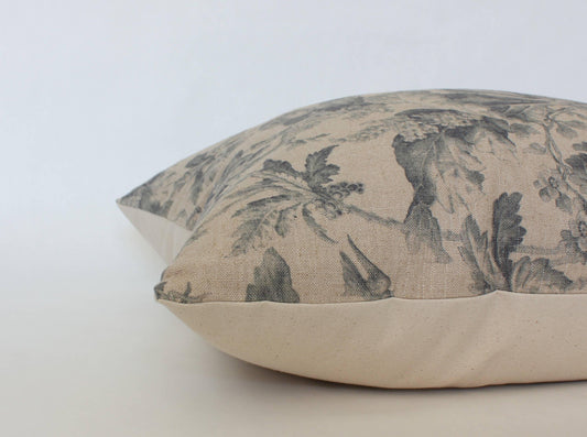 Decorative beige pillow with gray floral leaves pattern on white background. Come see us at Awaken, Franklin, Tennessee