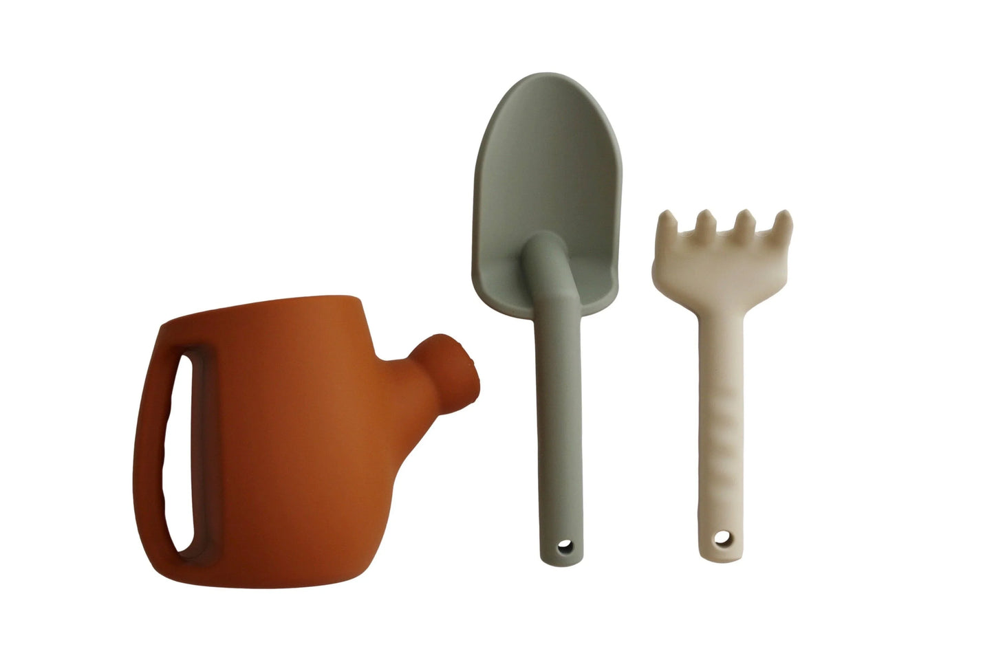 Kids gardening tools set with orange watering can, green shovel, and beige rake. Come see us at Awaken, Franklin, Tennessee