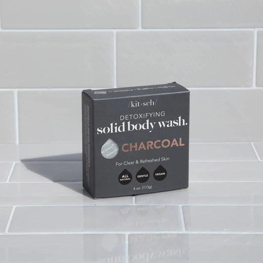 Kitsch detoxifying charcoal solid body wash box on white tile background. Come see us at Awaken, Franklin, Tennessee