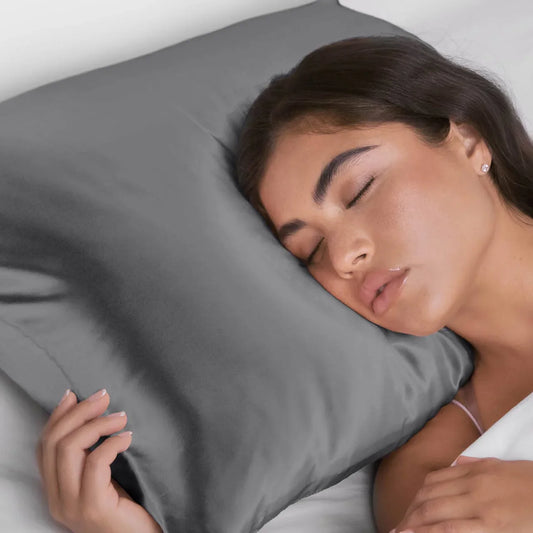 Woman sleeping peacefully on a smooth gray silk pillowcase, close-up face shot. Come see us at Awaken, Franklin, Tennessee