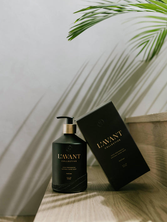L'AVANT Collective hand soap and box on wood table, palm shadow, Come see us at Awaken, Franklin, Tennessee