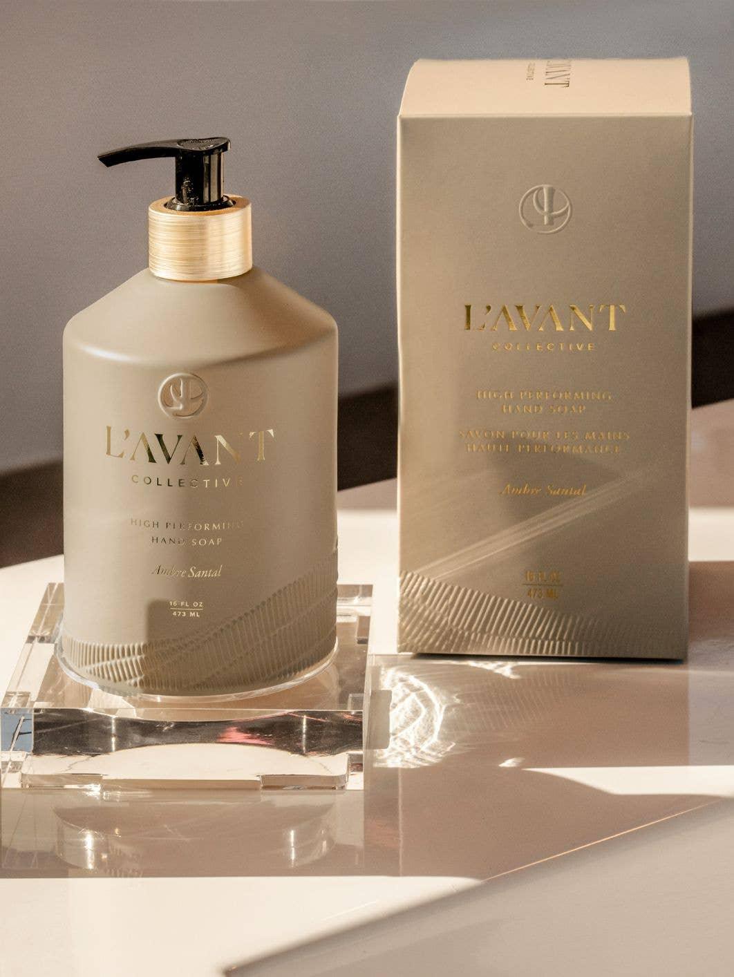L'Avant Collective high performing hand soap bottle and box in beige with gold text on white surface. Come see us at Awaken, Franklin, Tennessee
