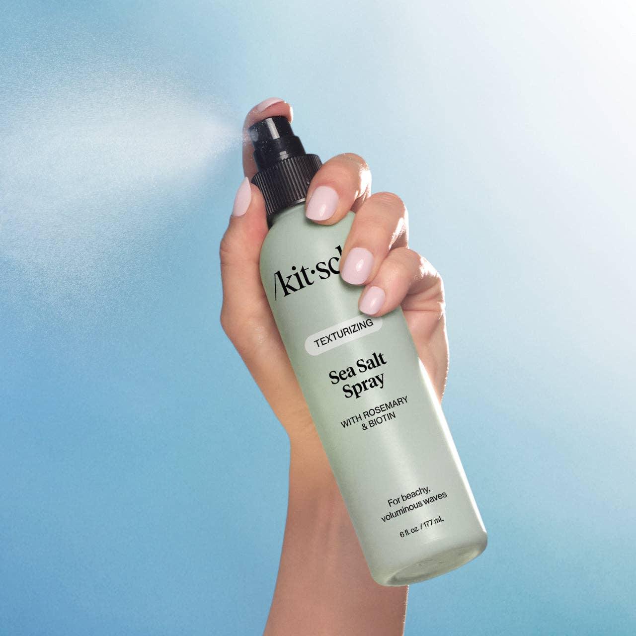 Hand spraying Kitsch Sea Salt Spray for textured, beachy waves. Come see us at Awaken, Franklin, Tennessee