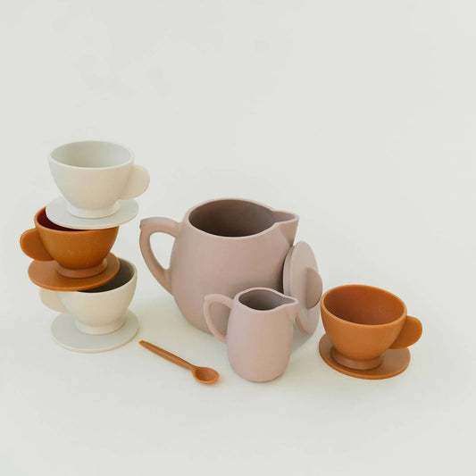Minimalist ceramic tea set with teapot, creamer, cups in neutral tones on white. Come see us at Awaken, Franklin, Tennessee