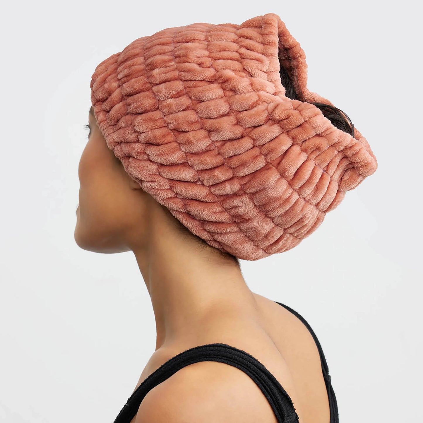 Woman wearing textured pink plush head wrap towel with black tank top. Come see us at Awaken, Franklin, Tennessee