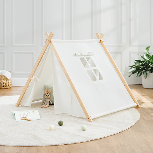 White kids play tent with wooden frame, crocheted bunny, play balls, and book on round rug in bright room. Come see us at Awaken, Franklin, Tennessee