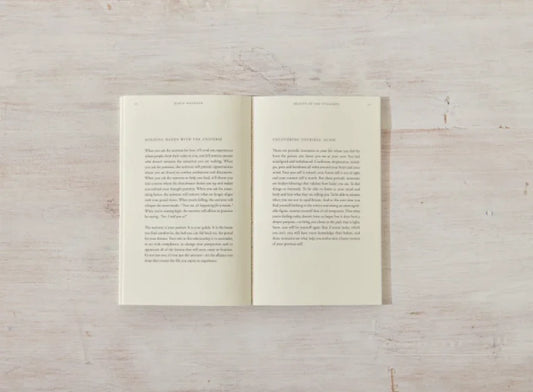 Open book with text on wooden table in soft light, minimalistic scene. Come see us at Awaken, Franklin, Tennessee