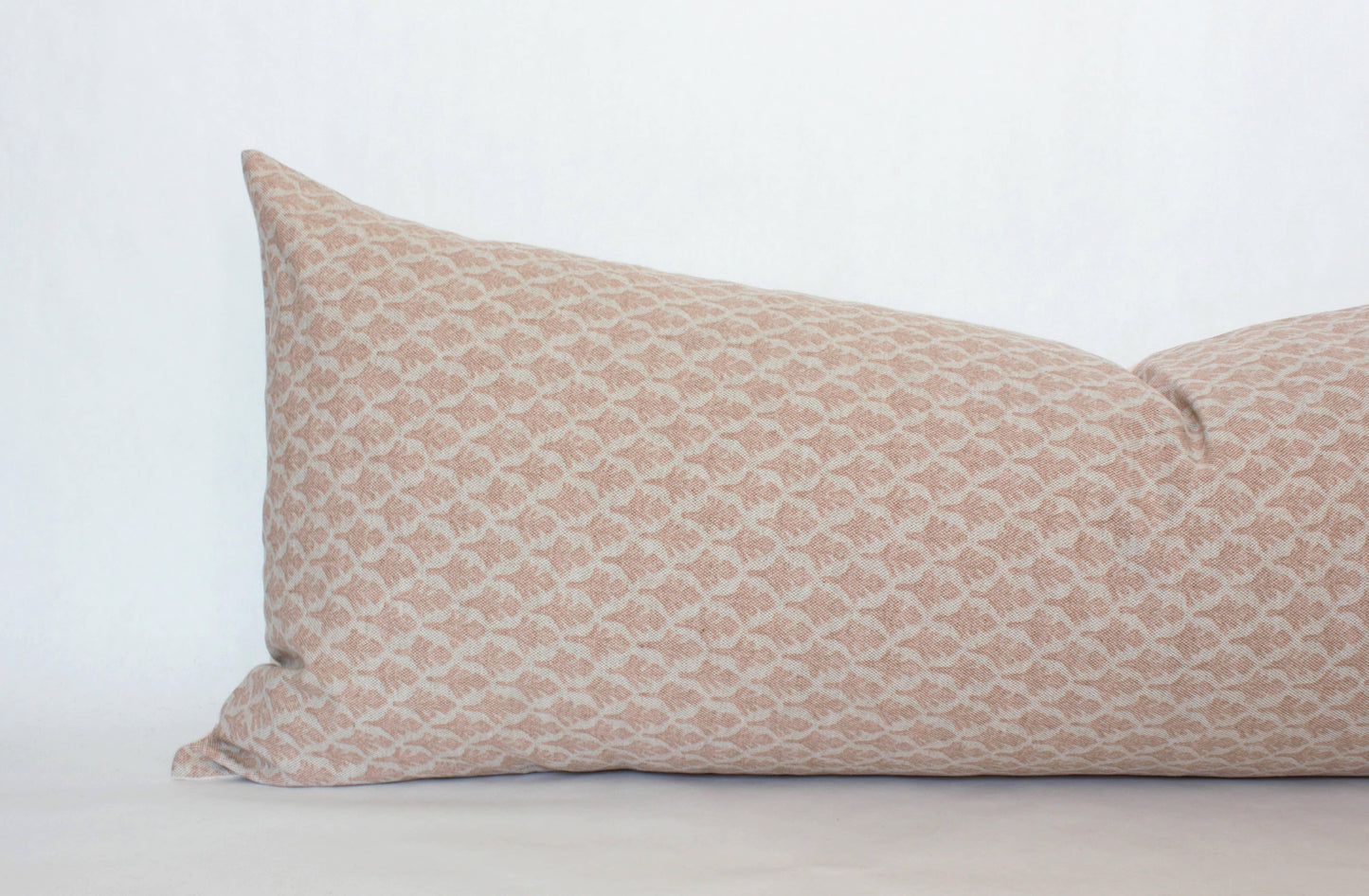 Rectangular beige pillow with subtle geometric pattern on white background, Come see us at Awaken, Franklin, Tennessee