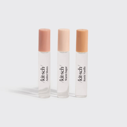 Three Kitsch roll-on perfumes Amber Shores, Warm Sugar, Rustic Vanilla with pastel caps. Come see us at Awaken, Franklin, Tennessee