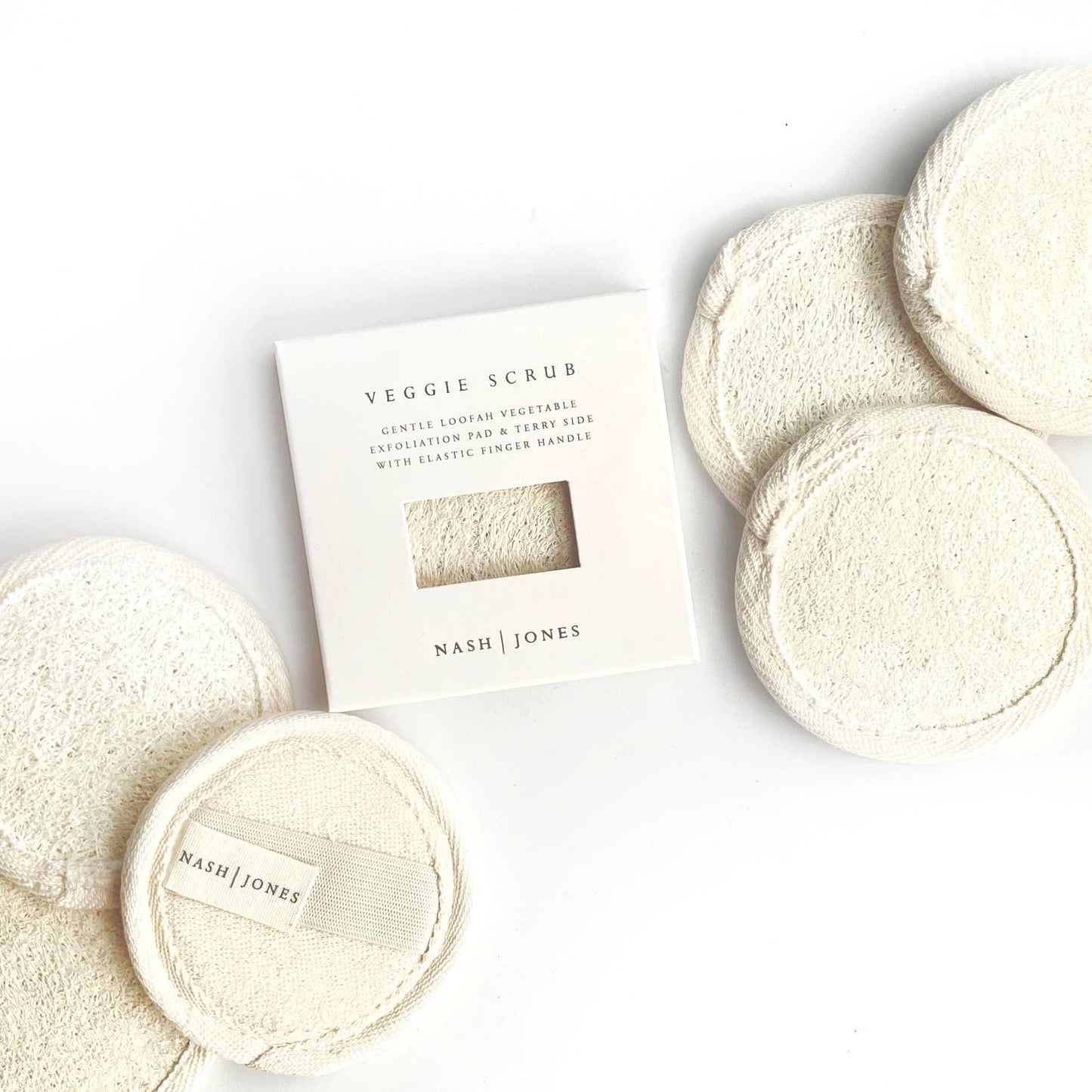Nash Jones Veggie Scrub gentle loofah vegetable exfoliation pads with elastic finger handle, natural color. Come see us at Awaken, Franklin, Tennessee