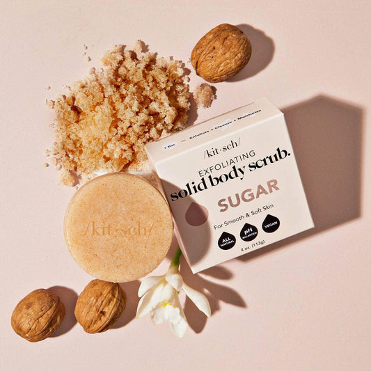 Sugar exfoliating solid body scrub with sliced nuts, flower, and scrub pile, Come see us at Awaken, Franklin, Tennessee