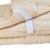Light beige bamboo silk quilt with fabric tie straps on white background. Come see us at Awaken, Franklin, Tennessee