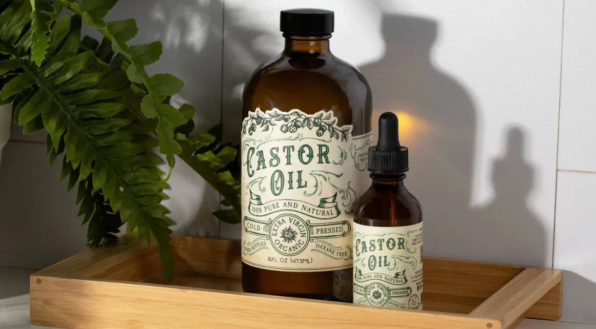 Castor oil bottles on a wooden tray with green leaves, Come see us at Awaken, Franklin, Tennessee.