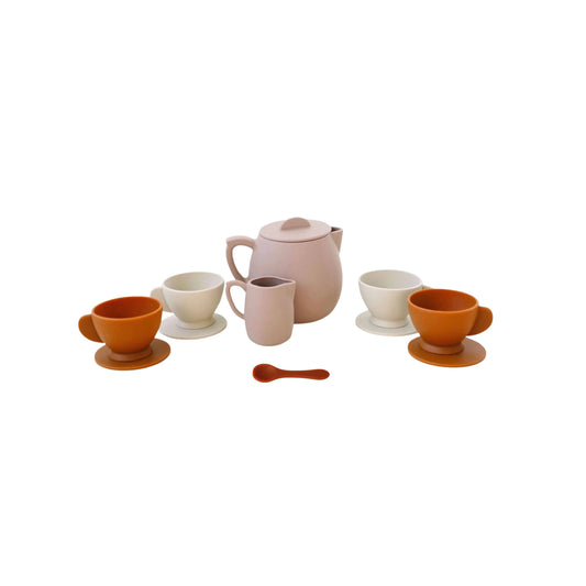 Pink and orange modern tea set with cups, teapot, creamer, and spoon. Come see us at Awaken, Franklin, Tennessee.
