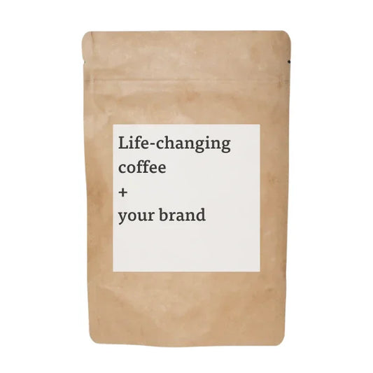 Brown coffee bag with 'Life-changing coffee + your brand' text. Come see us at Awaken, Franklin, Tennessee.