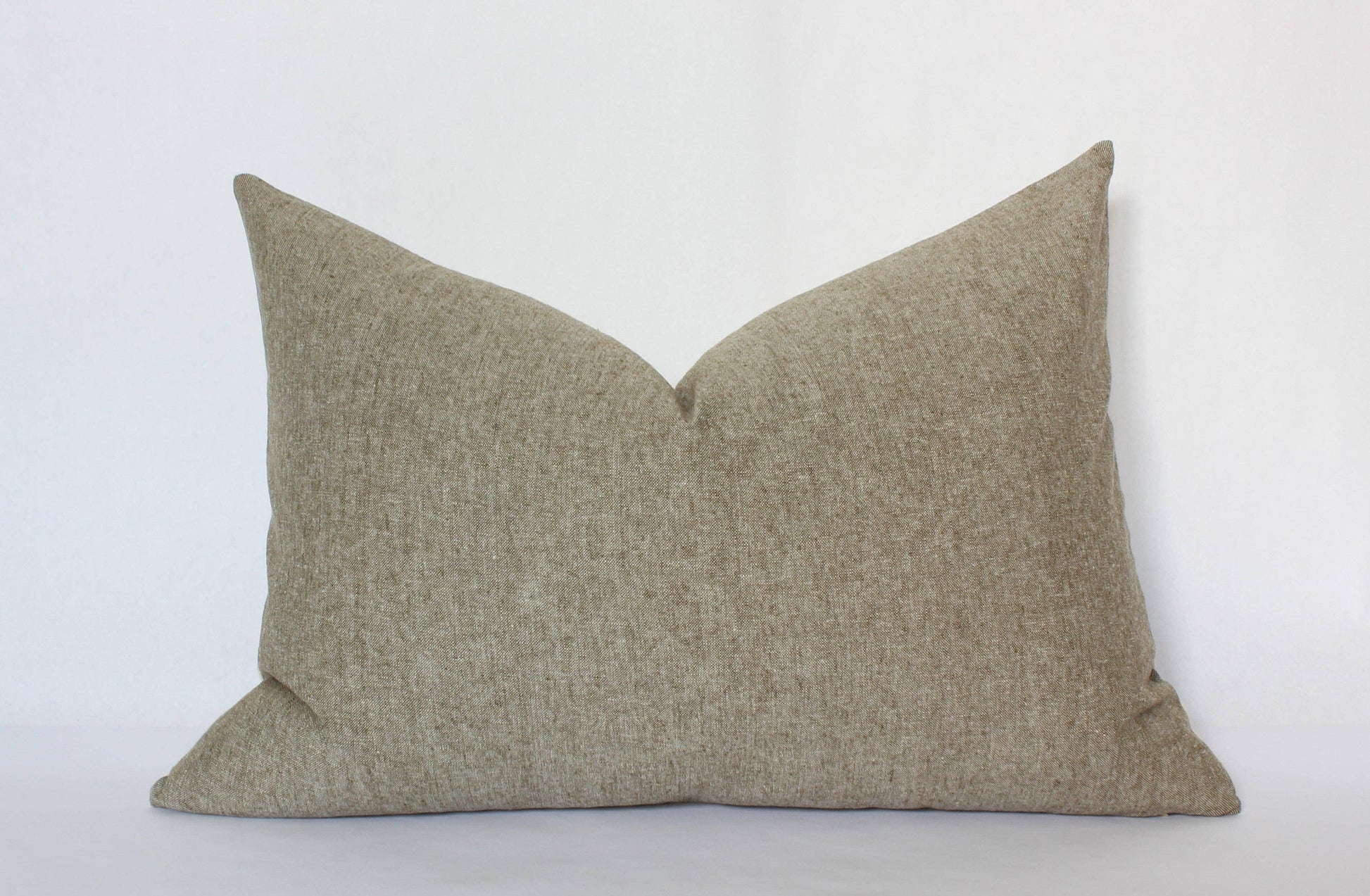 Neutral beige textured rectangular pillow on white background. Come see us at Awaken, Franklin, Tennessee