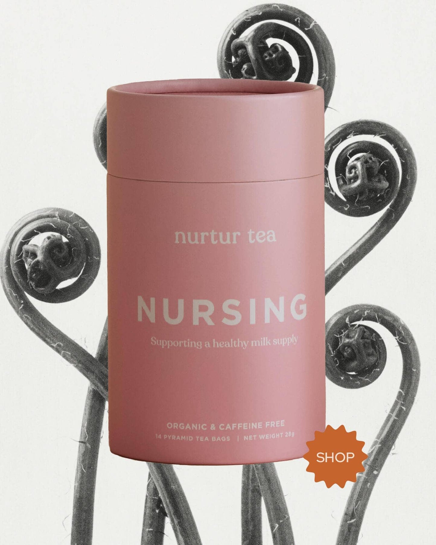 Pink container of nurtur tea nursing blend with organic, caffeine-free label and decorative ferns. Come see us at Awaken, Franklin, Tennessee