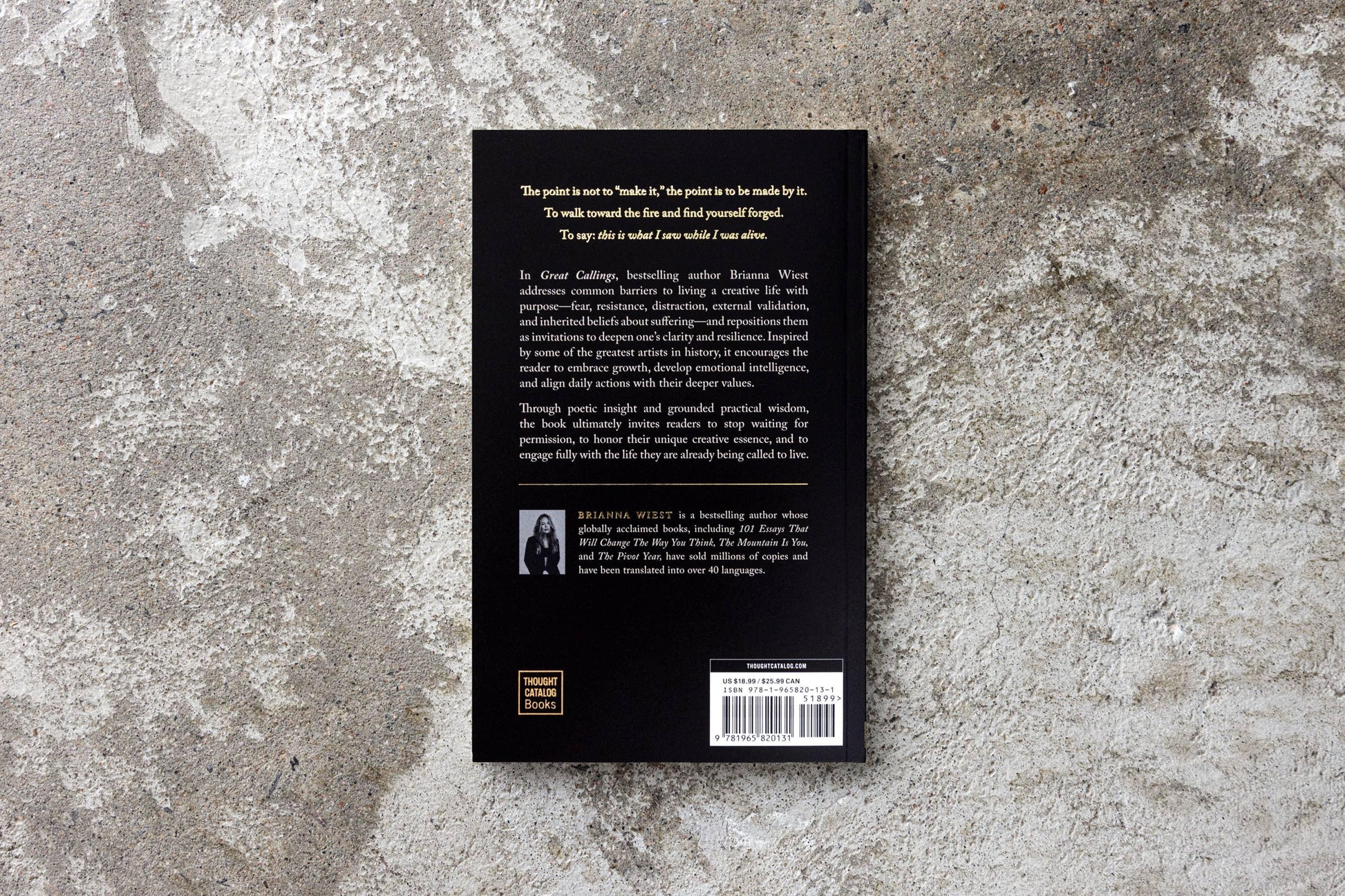 Back cover of the book Great Callings by Brianna Wiest on a textured concrete surface. Come see us at Awaken, Franklin, Tennessee