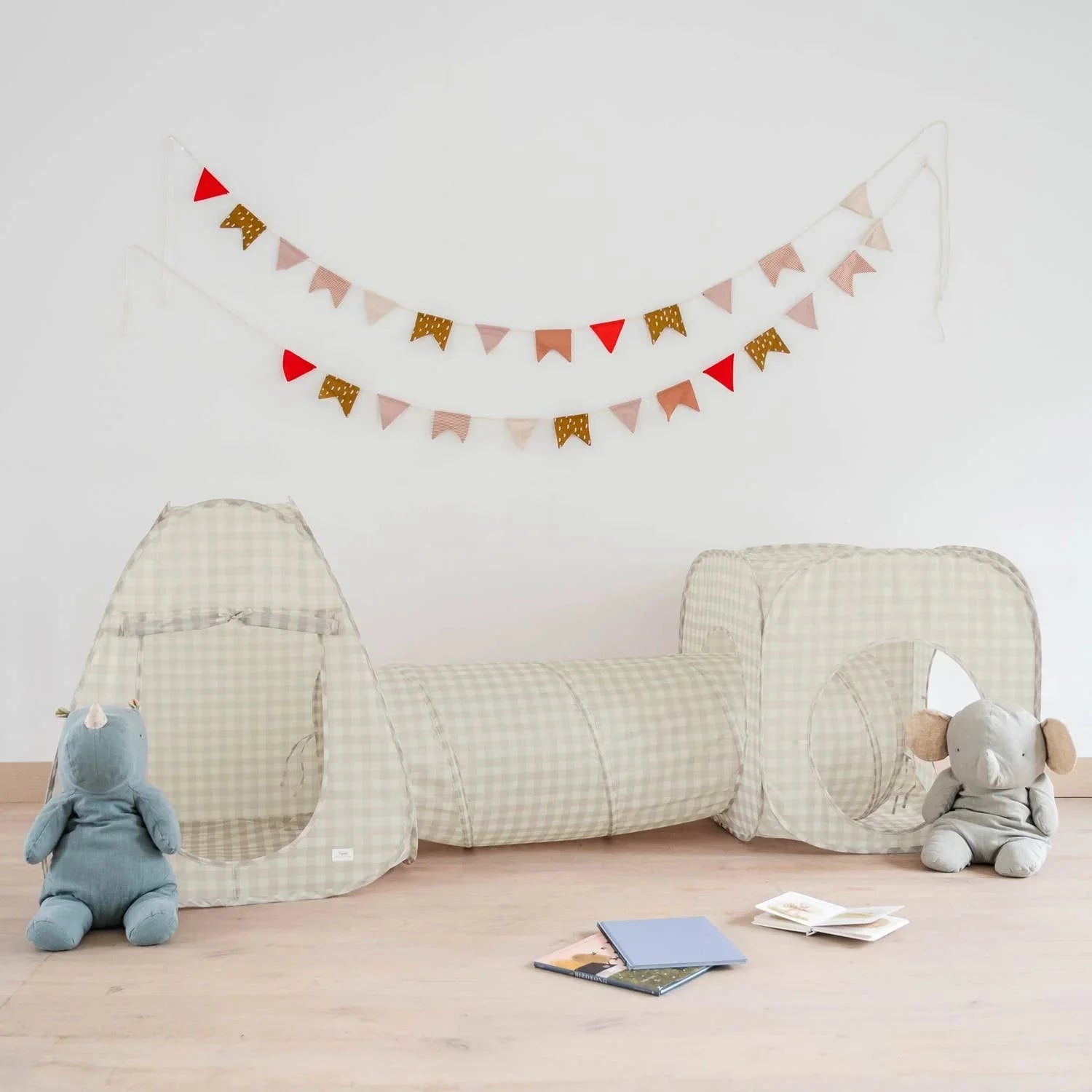 Checkered beige play tunnel tent with rhino and elephant plush toys, wall bunting flags; Come see us at Awaken, Franklin, Tennessee