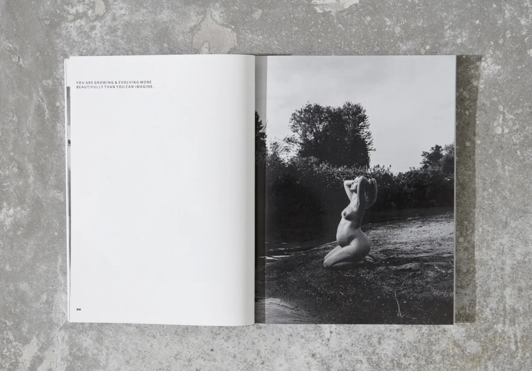 Open magazine on concrete floor with black and white maternity photo and growth quote. Come see us at Awaken, Franklin, Tennessee