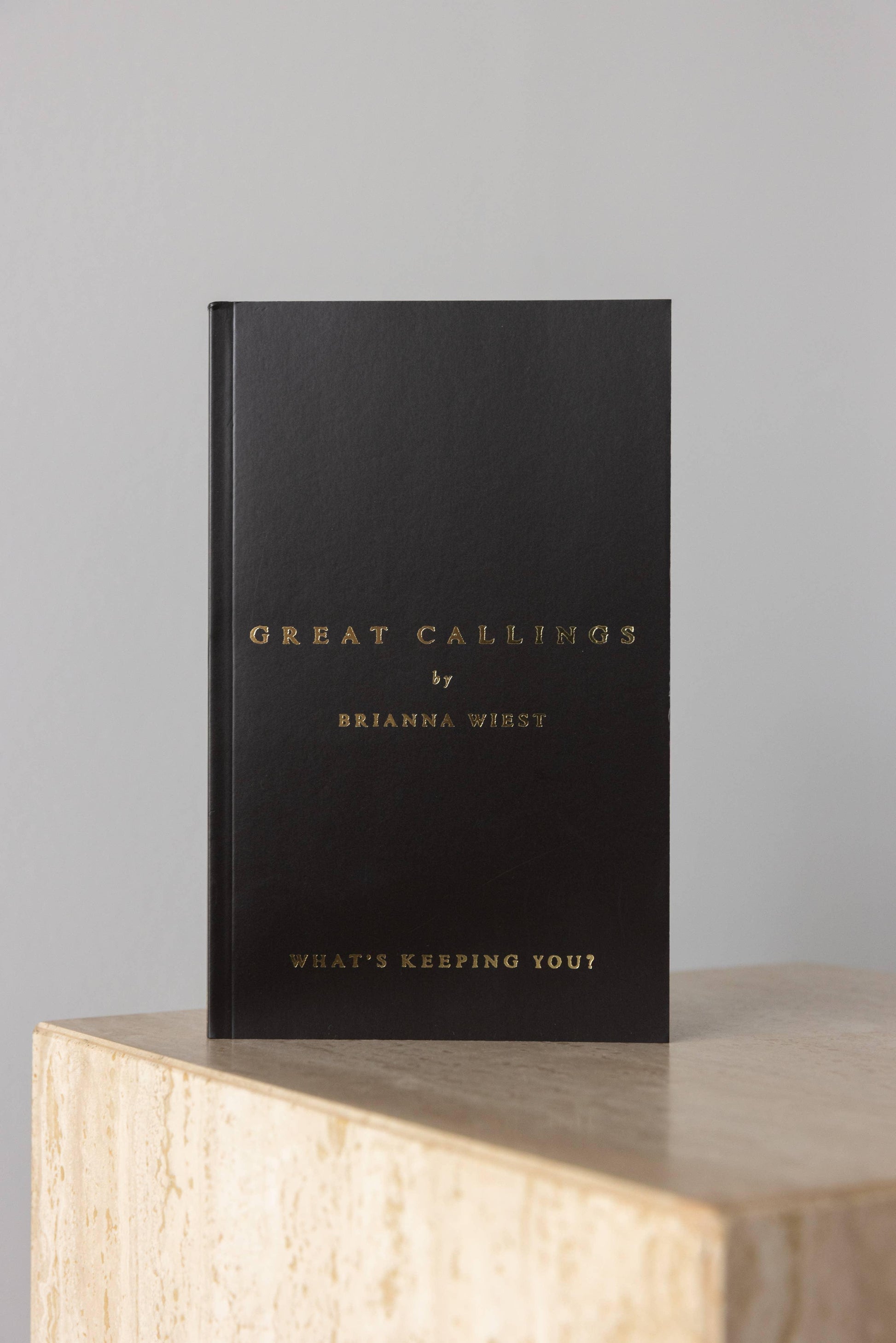 Black book titled Great Callings by Brianna Wiest on marble surface Come see us at Awaken, Franklin, Tennessee