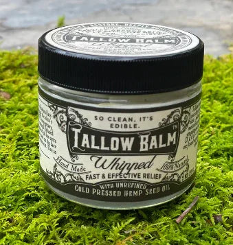Jar of handmade Tallow Balm Whipped with hemp seed oil on green moss background. Come see us at Awaken, Franklin, Tennessee
