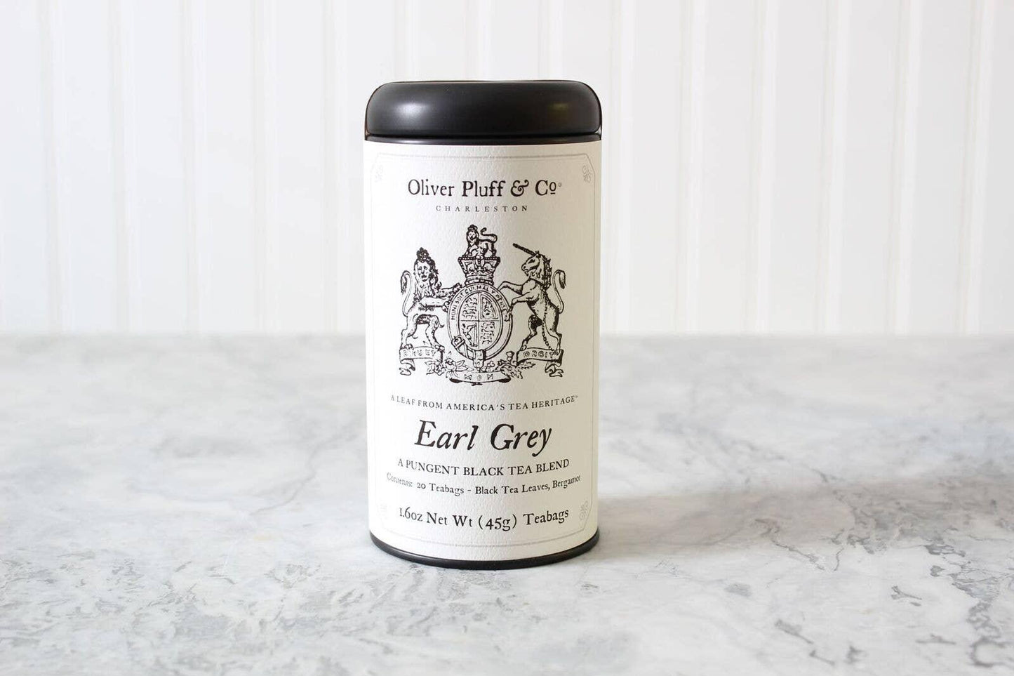 Oliver Pluff & Co Earl Grey black tea tin on marble surface Come see us at Awaken, Franklin, Tennessee