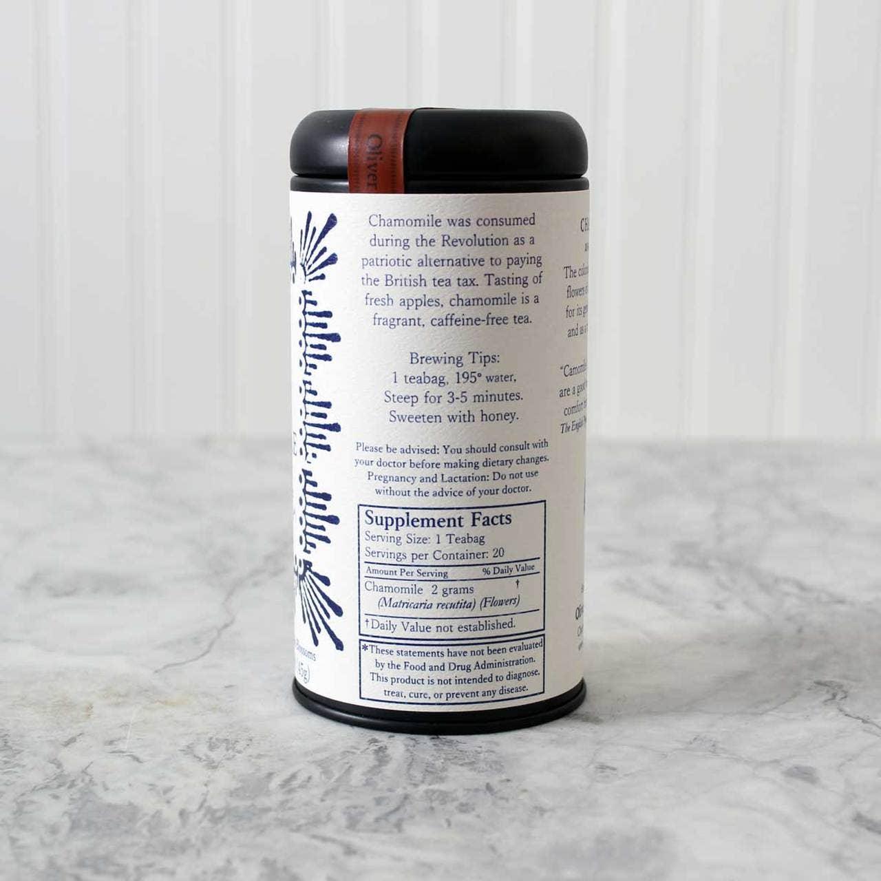 Chamomile tea container with brewing tips and supplement facts on marble surface. Come see us at Awaken, Franklin, Tennessee