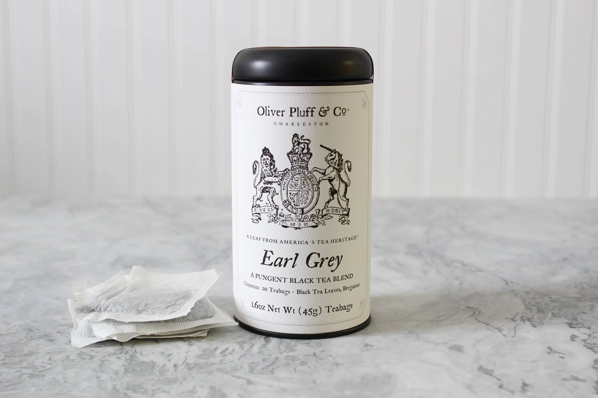 Oliver Pluff & Co Earl Grey black tea blend tin with teabags on marble surface Come see us at Awaken, Franklin, Tennessee