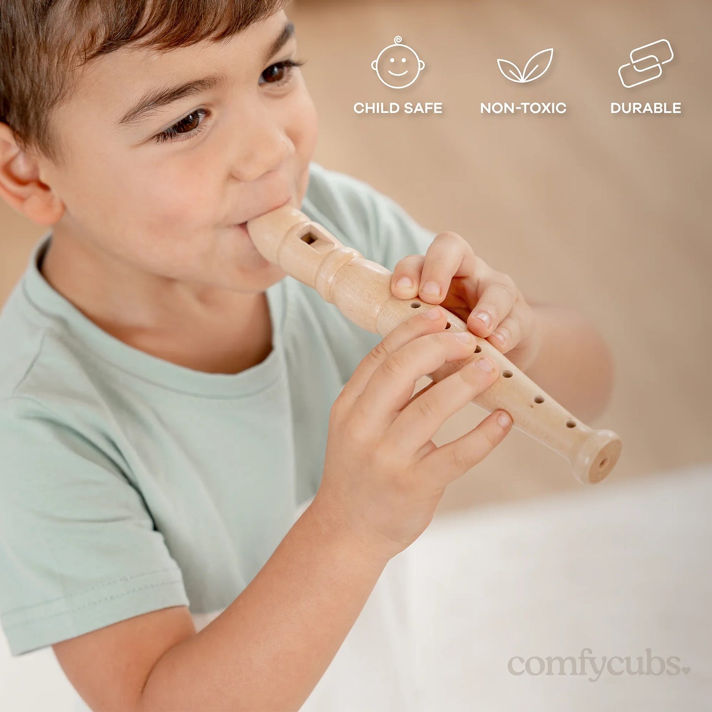 Child playing wooden recorder flute, child safe, non-toxic, durable. Come see us at Awaken, Franklin, Tennessee.