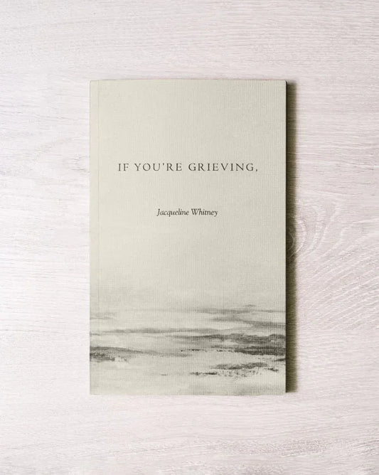 Book titled 'If You're Grieving' by Jacqueline Whitney on a light wooden surface, Come see us at Awaken, Franklin, Tennessee