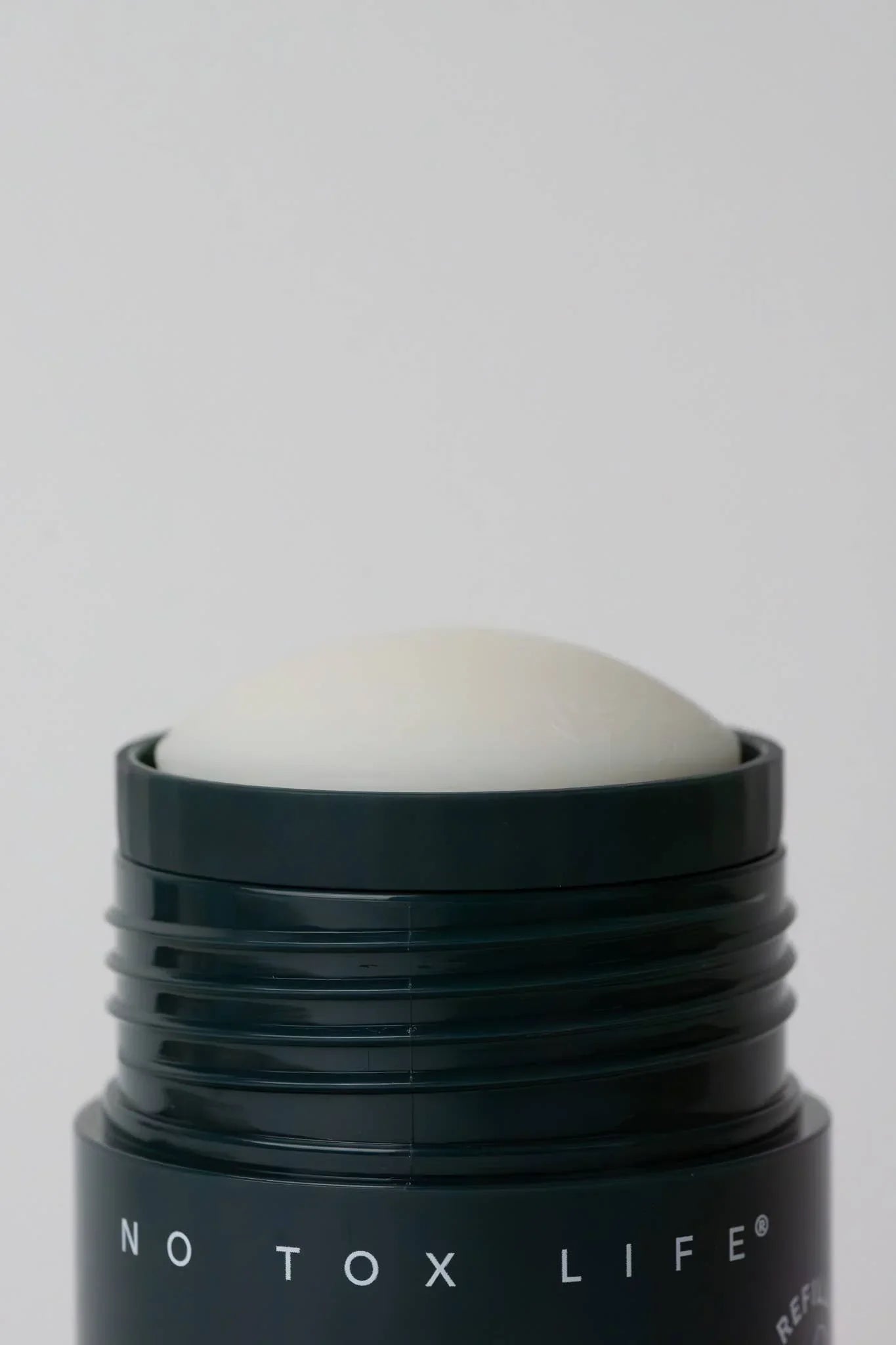 Close-up of deodorant stick labeled No Tox Life against plain background. Come see us at Awaken, Franklin, Tennessee