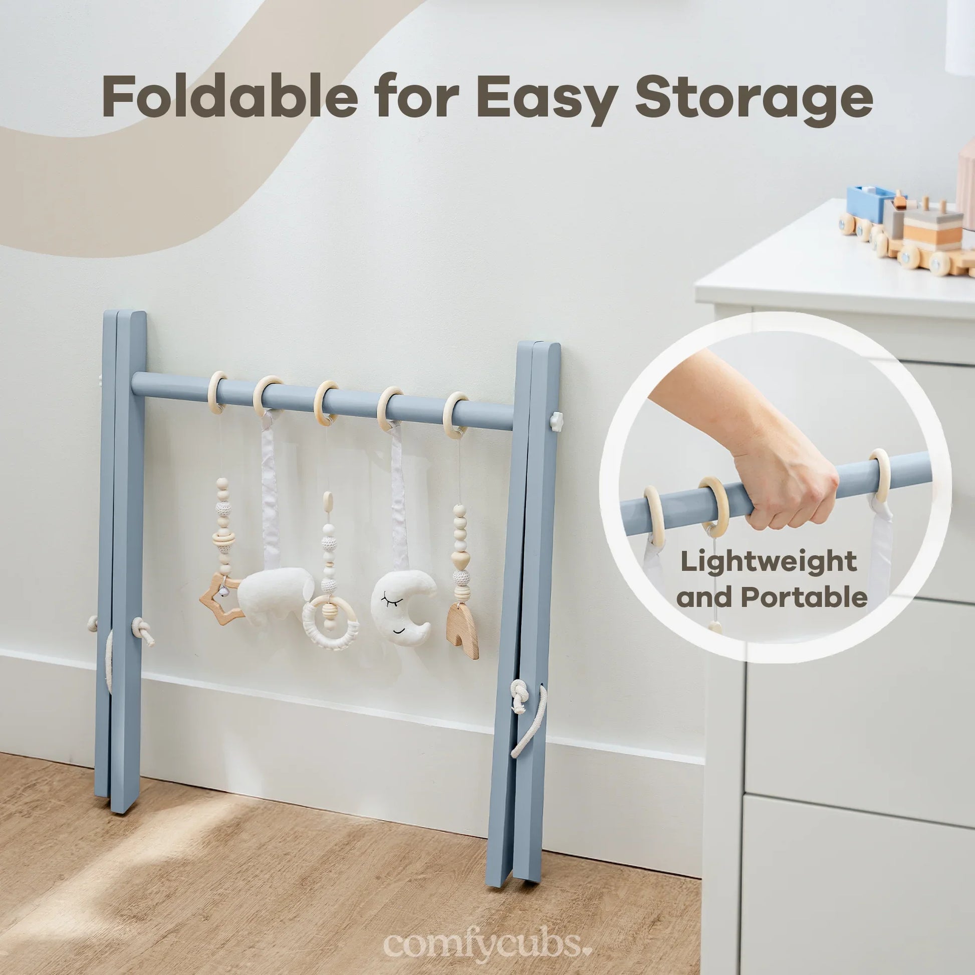 Foldable blue baby play gym with wooden and plush hanging toys, lightweight and portable. Come see us at Awaken, Franklin, Tennessee