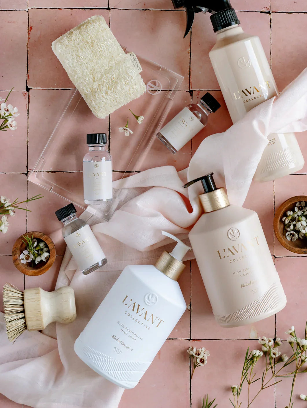 L’AVANT Collective cleaning products and flowers on pink tile, Come see us at Awaken, Franklin, Tennessee