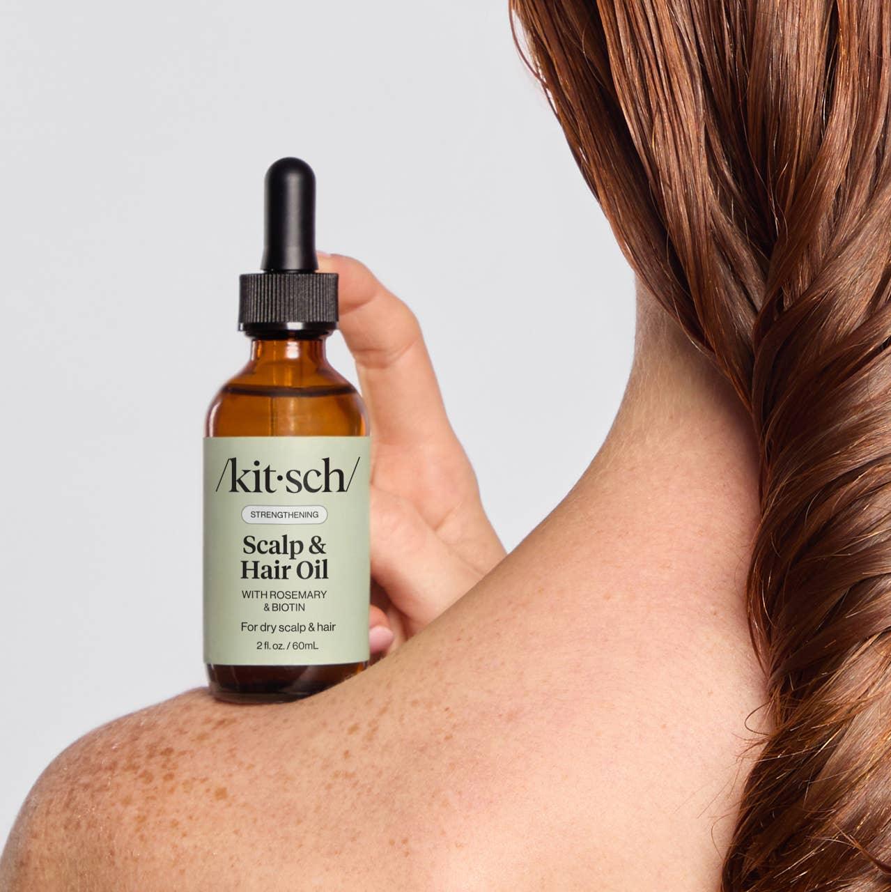 Kitsch Scalp & Hair Oil bottle held by woman with wet hair braid, Come see us at Awaken, Franklin, Tennessee