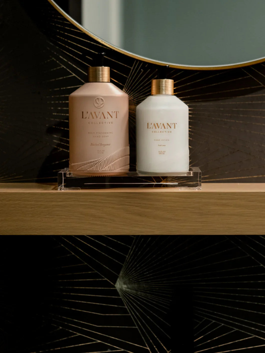 L'AVANT Collective hand soap and lotion on wooden shelf, modern bathroom decor. Come see us at Awaken, Franklin, Tennessee.