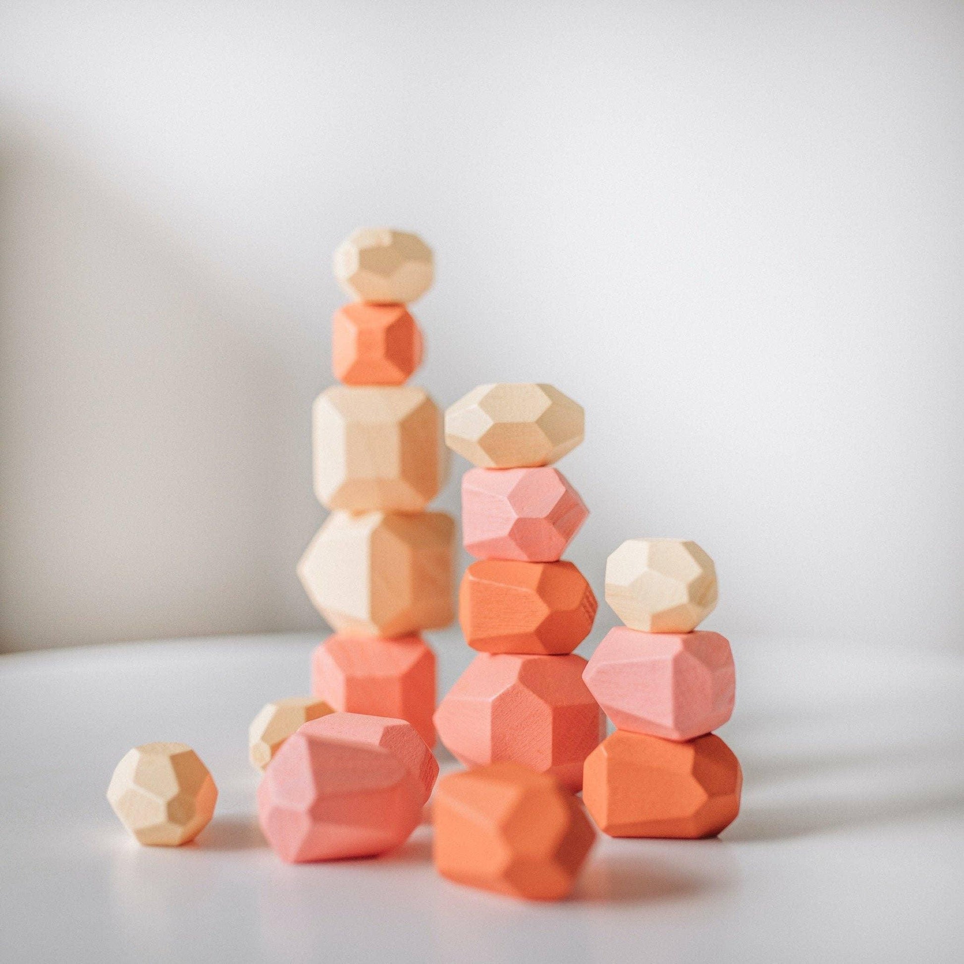Stacked natural and pastel wooden geometric blocks on white surface, modern kids toy. Come see us at Awaken, Franklin, Tennessee