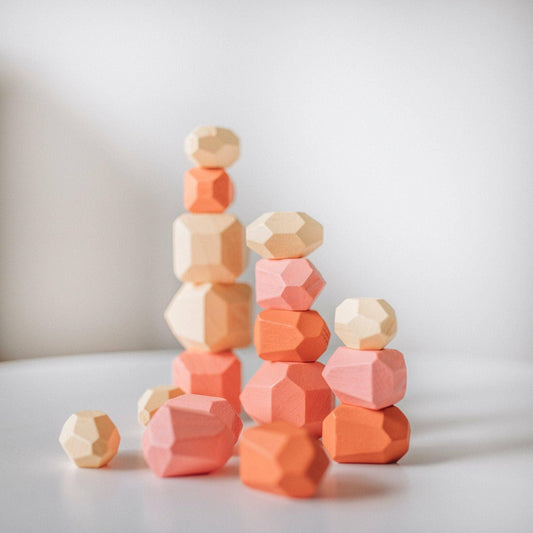 Stacked natural and pastel wooden geometric blocks on white surface, modern kids toy. Come see us at Awaken, Franklin, Tennessee