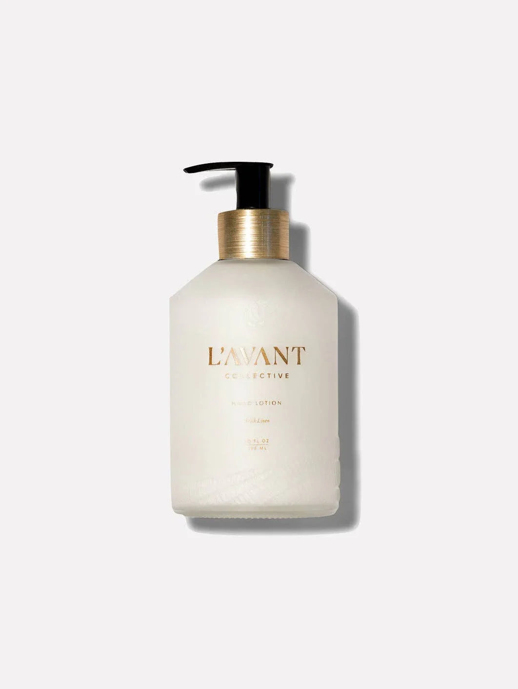 L'AVANT Collective hand lotion bottle with gold label, pump top. Come see us at Awaken, Franklin, Tennessee.